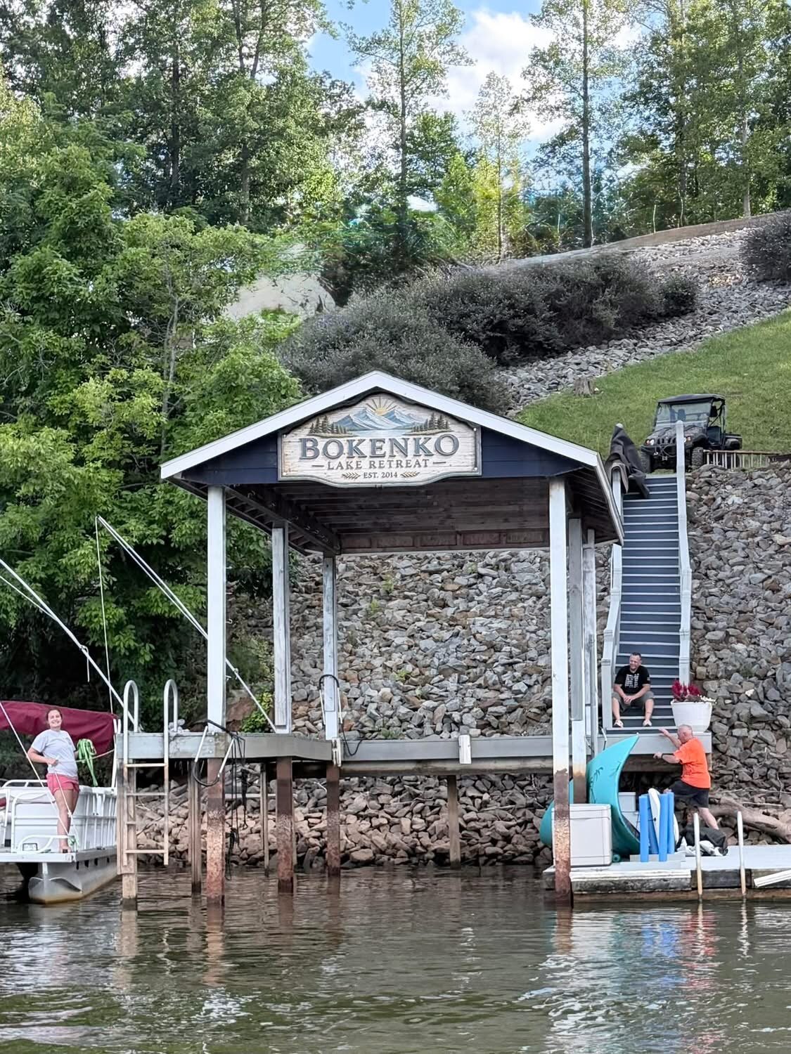 Completed Bokenko Lake Retreat sign installed on the lakefront boathouse
