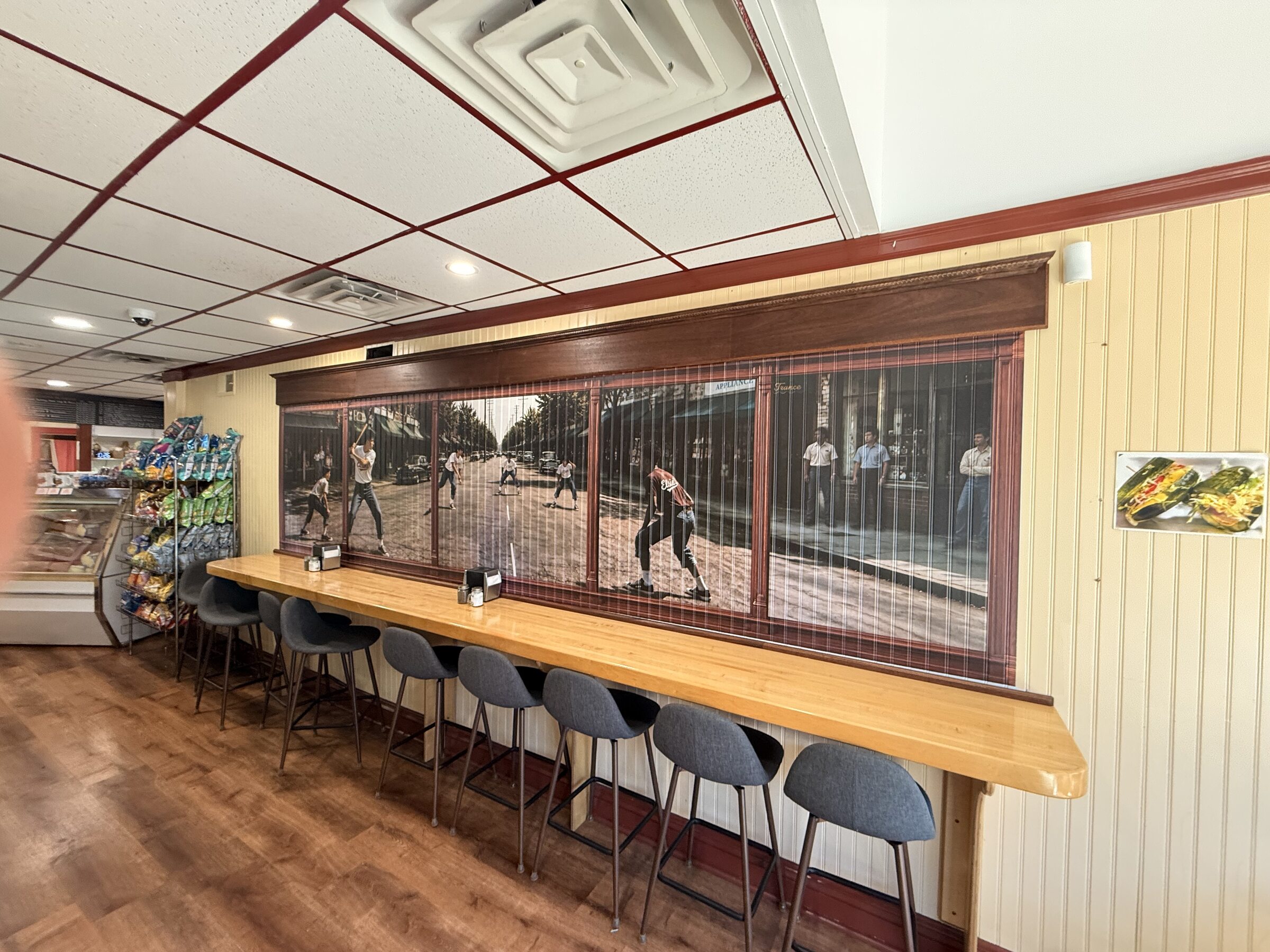 Completed Elsie's dining room with the stickball mural framed by a mahogany valance