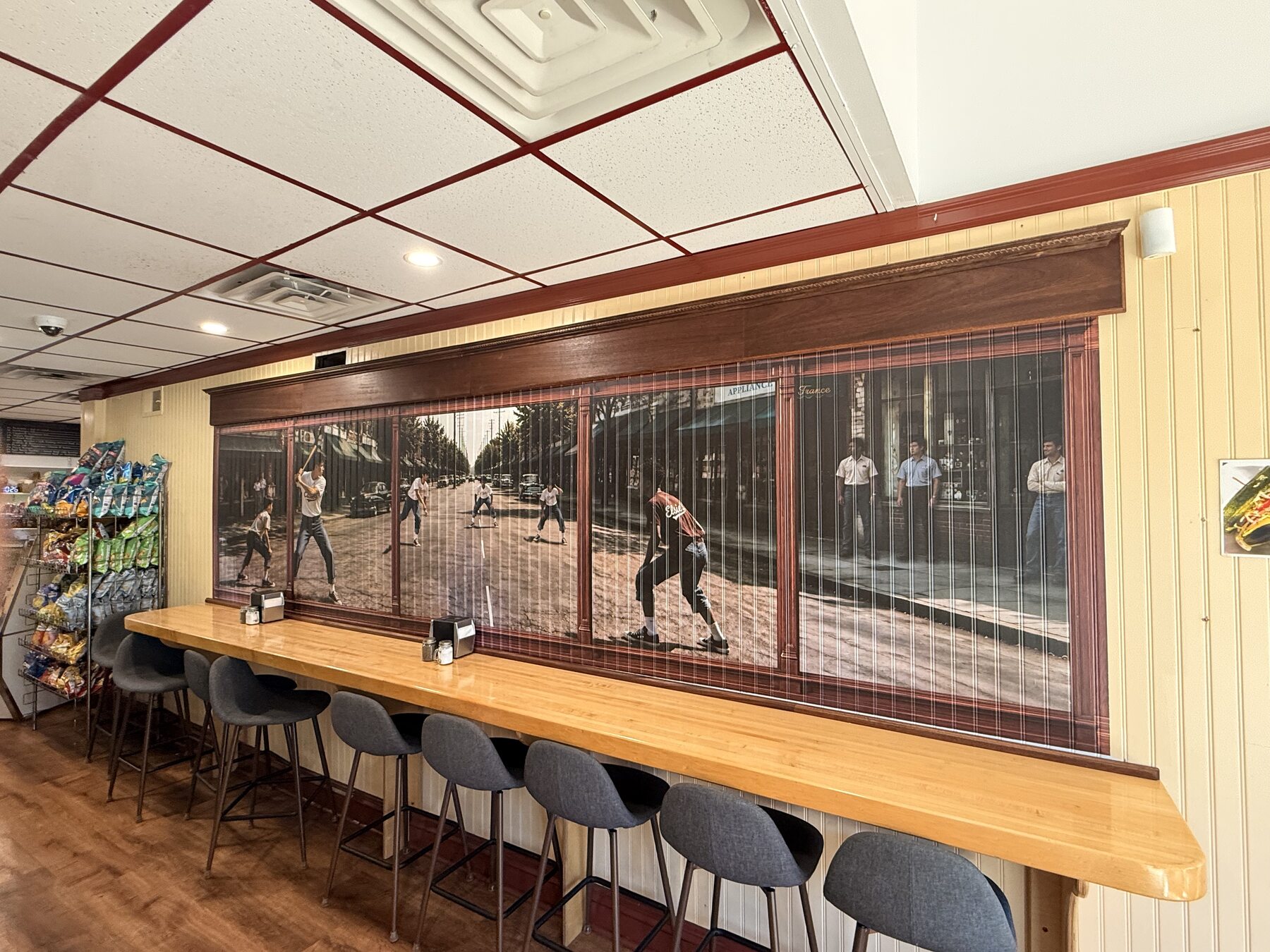 Wide view of the stickball mural and surrounding dining room