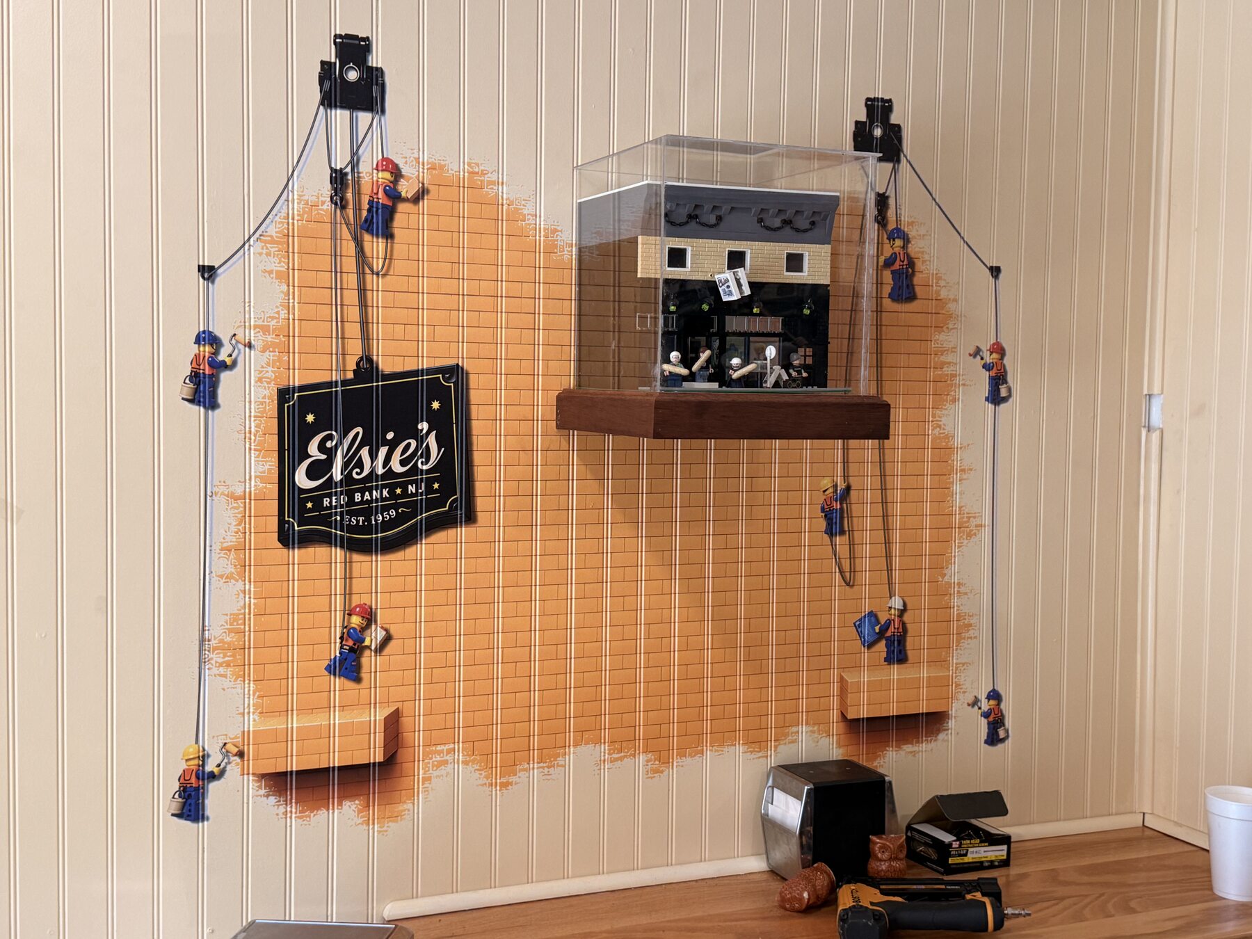 Mahogany shelf and LEGO figure beside the themed wall graphic