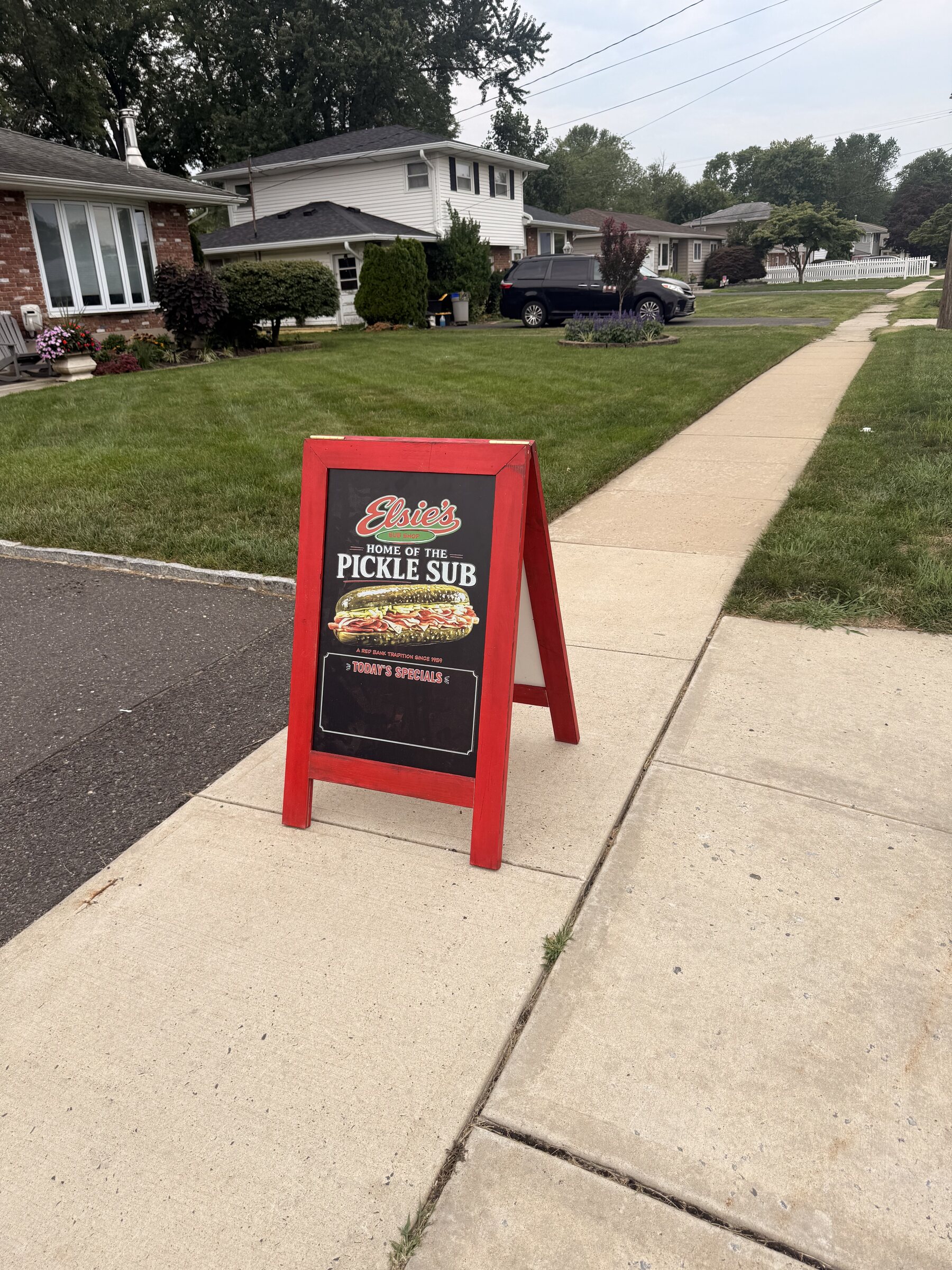 Pickle sub sign on the sidewalk