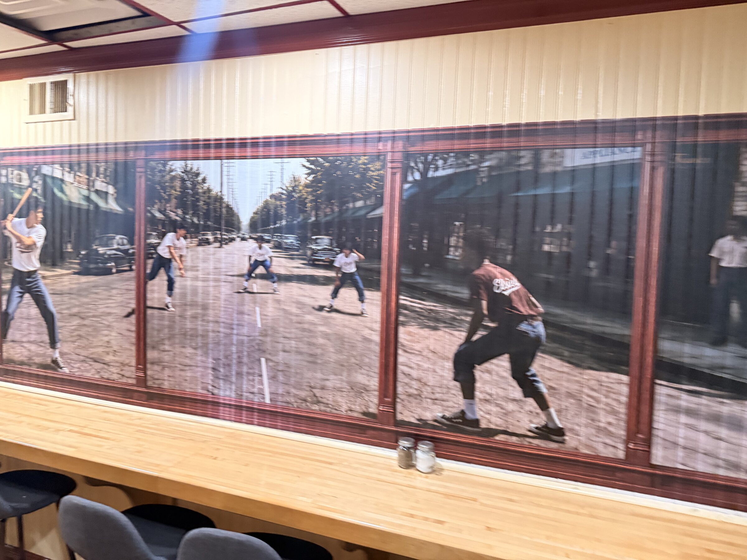 Wide installation view of the stickball mural