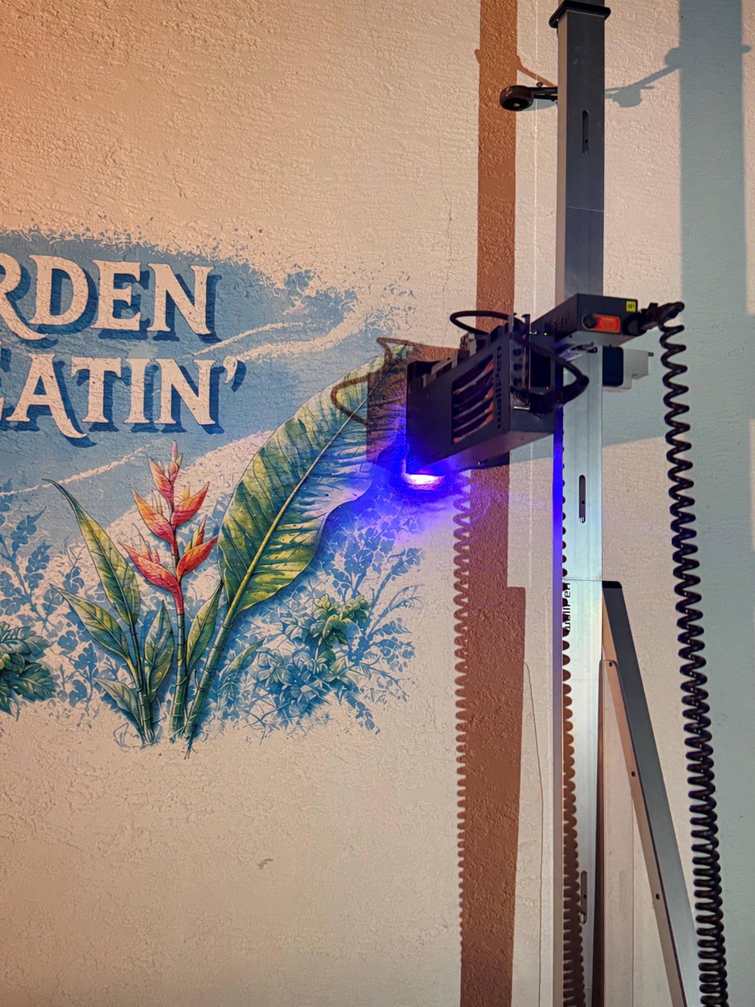 Late printing stage of the Garden of Eatin’ artwork on the exterior stucco wall