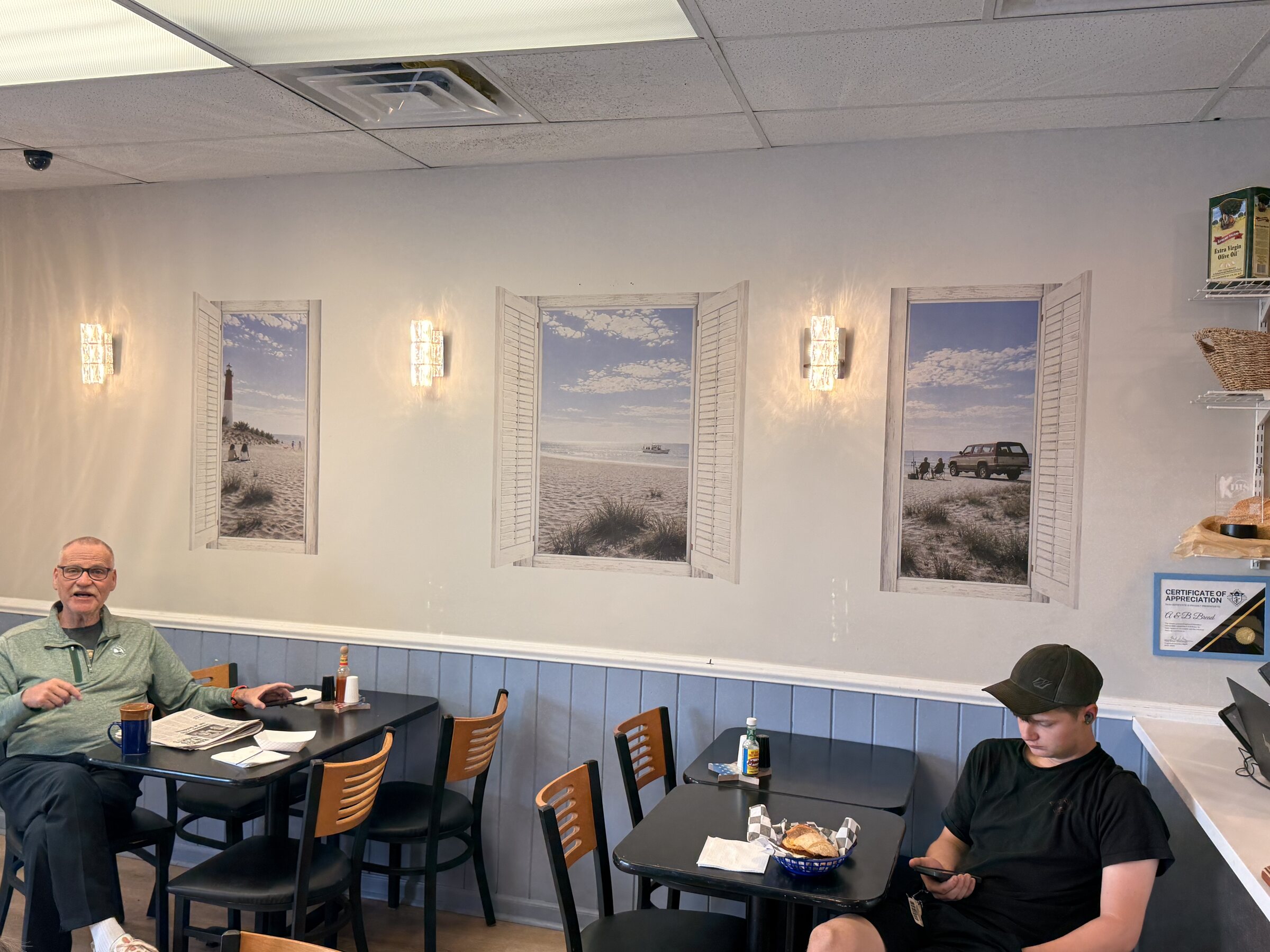 Completed coastal-window scene installed on site at Krust Cafe