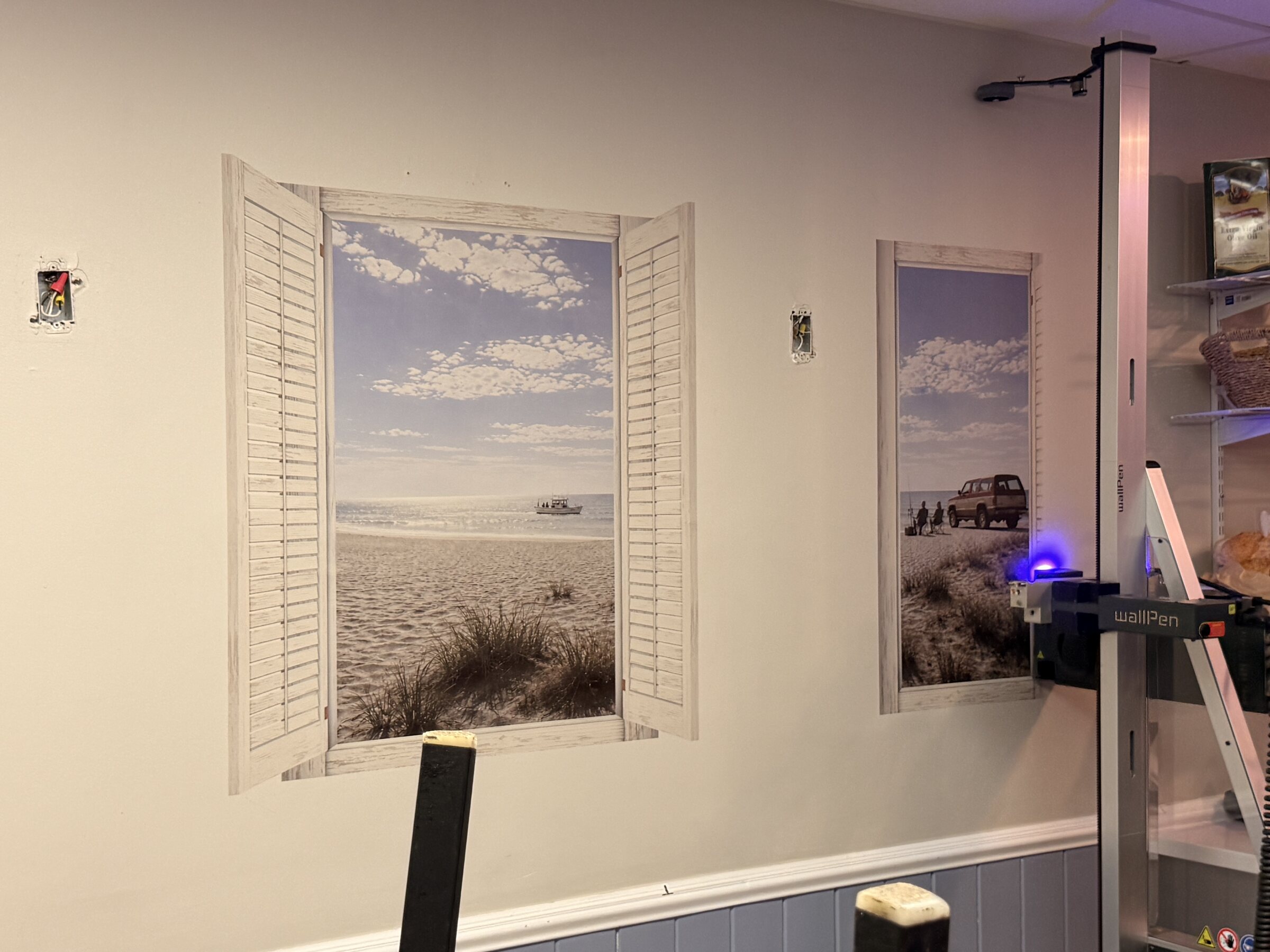 Coastal windows being printed directly on site at Krust Cafe as UAF's printer traverses the wall
